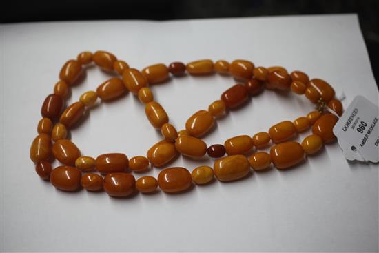 A single strand oval amber bead necklace, 104cm.